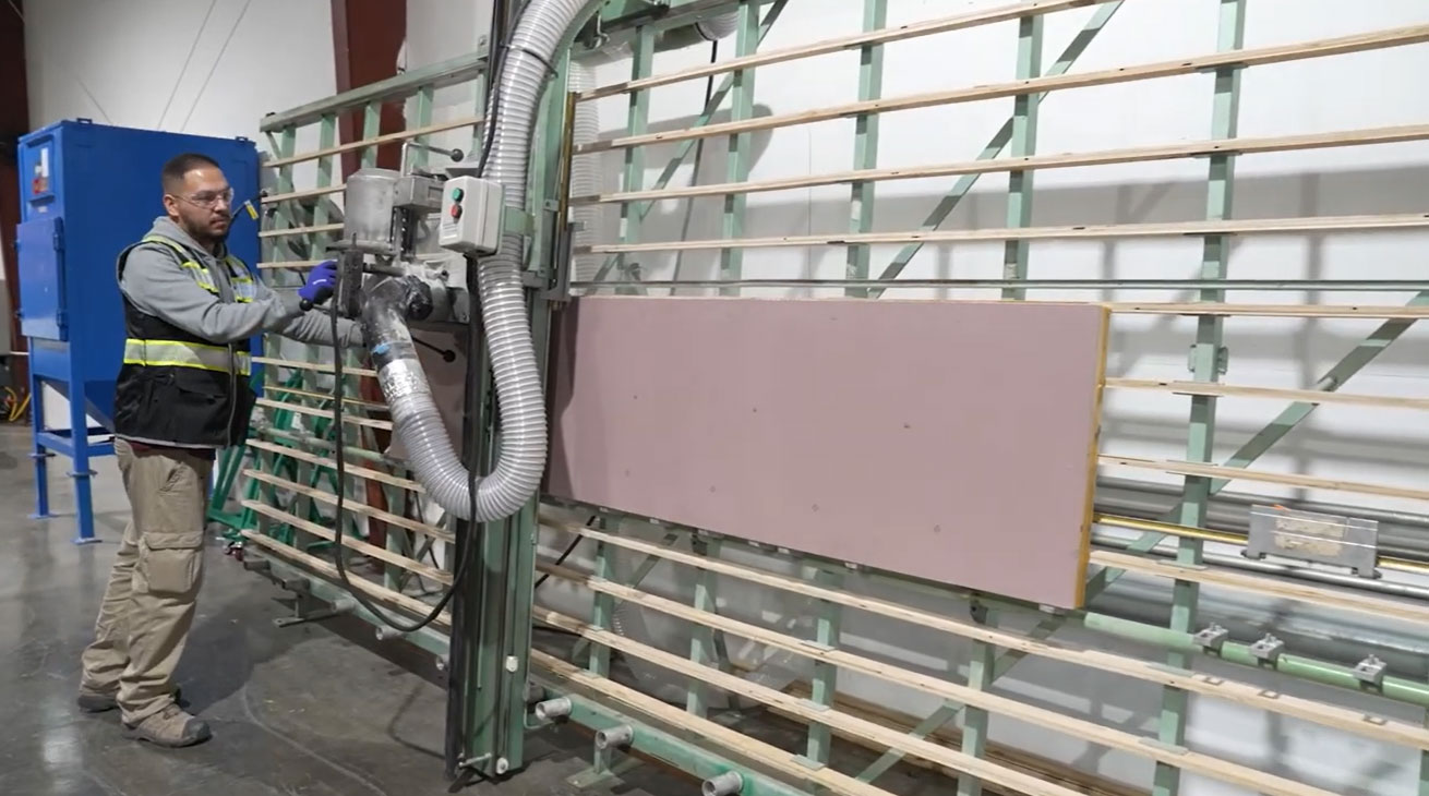 4C team member operating a panel saw on the production floor